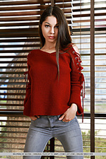 Delphina delphina bares her perky tits as she strips in front of the camera.