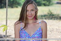 Mirabella alluring mirabella shows off her tight body as she poses on the swing.