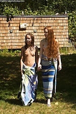 Innocent redheads strip and embrace outside