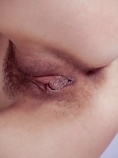 Iva iva strips on the bed as she bares her sweet, unshave pussy.