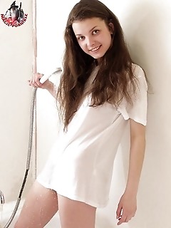 Hot brunette teen in a white t-shirt but without her panties having fun in the bathroom