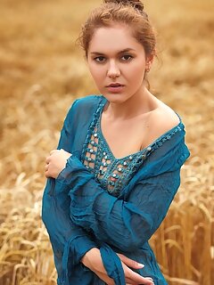 Jenya a jenya a strips in the field as she bares her slender body and meaty pussy.