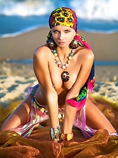 Colorful, vibrant, and enchanting model evoking a sexy sea gypsy by the beach.