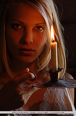 A lighted candle illuminates roxio sultry face and creates stunning silhouttes of her womanly curves and feminine mounds.