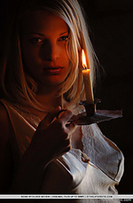 A lighted candle illuminates roxio sultry face and creates stunning silhouttes of her womanly curves and feminine mounds.
